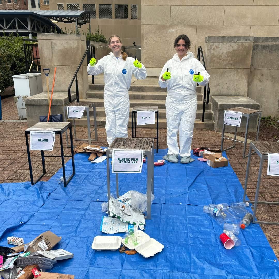 Students sort trash into waste categories at an earth month event 